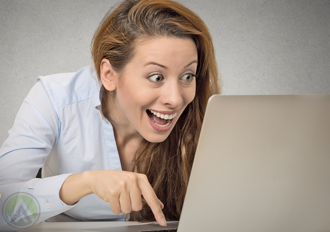 excited-woman-looking-at-laptop