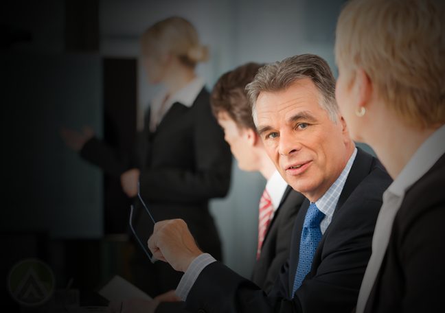 middle-aged-businessman-holding-glasses-listening-to-presentation