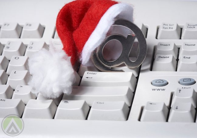 santa-claus-hat-on-at-sign-over-white-keyboard