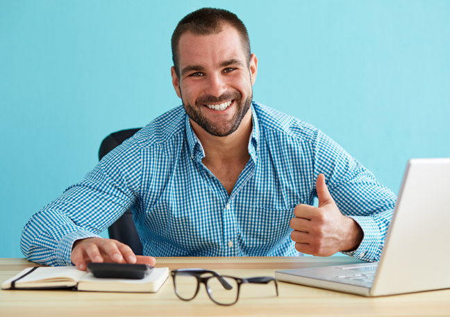 bearded-businessman-giving-thumbs-up-by-laptop