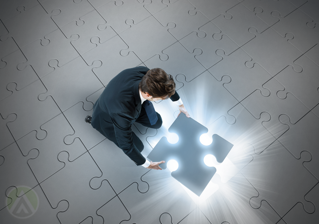 businessman-pickung-up-glowing-jigsaw-puzzle-piece-from-floor