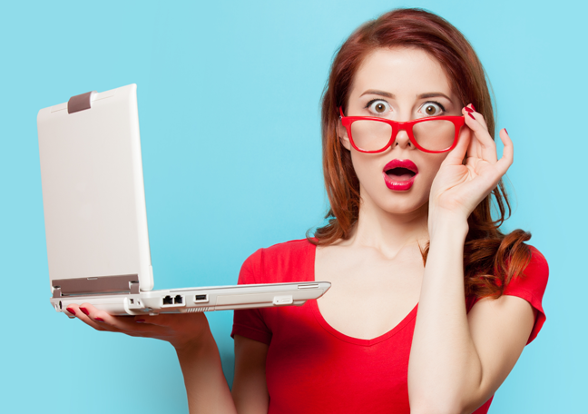 shocked-woman-in-glasses-reading-laptop