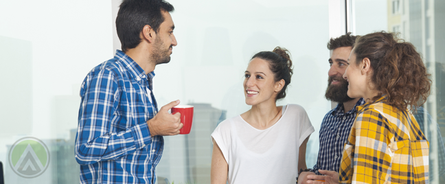 young-startup-boss-with-coffee-chatting-with-casual-employees