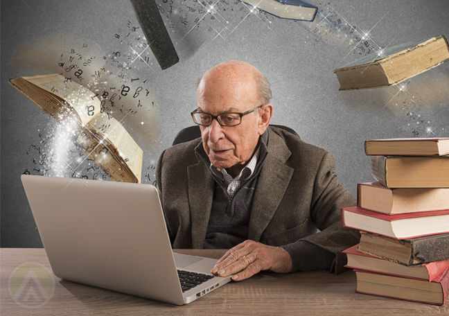 matured-man-with-piles-of-books-using-laptop