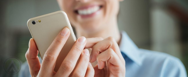 smiling-woman-dialing-smartphone