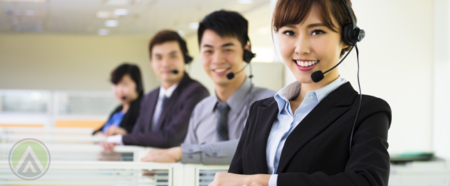 Asian-Filipino-customer-service-agents-standing-by-their-call-center-office-cubicles