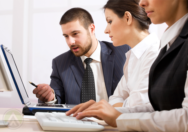 business-team-discussing-documents-on-laptop