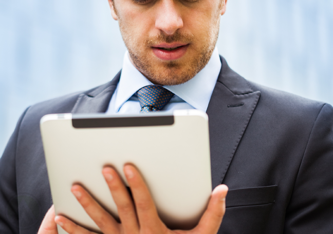 businessman-using-tablet-outide-office-building