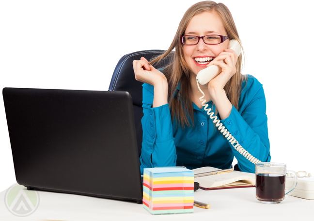 delighted-female-worker-speaking-on-phone-looking-at-laptop