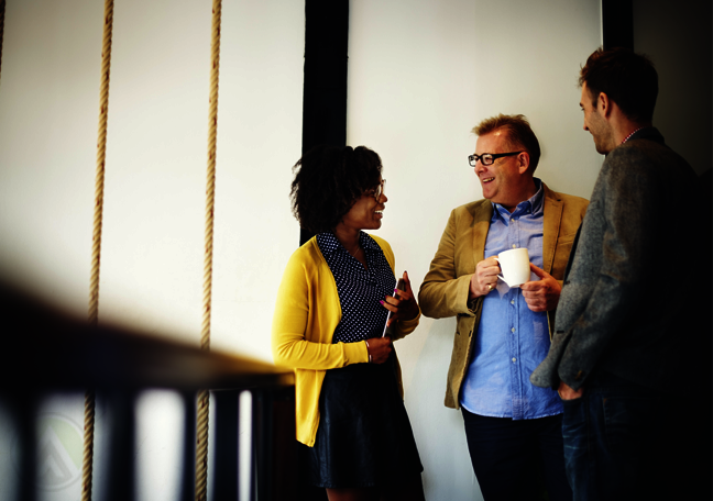 diverse-business-team-chatting-in-office-hallway