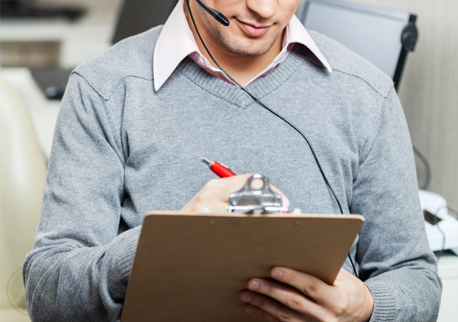 male-call-center-manager-writing-on-clipboard