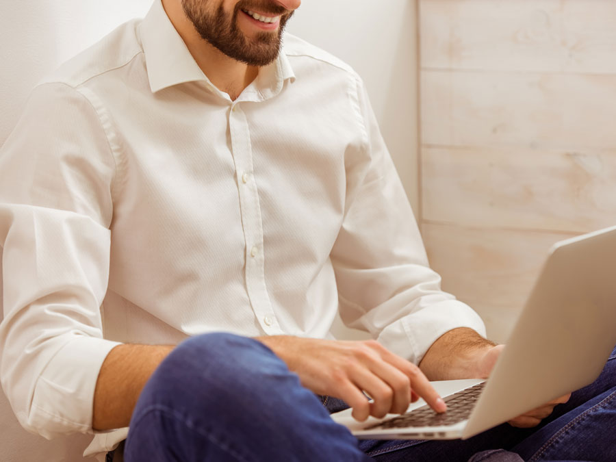 smiling businessman using laptop