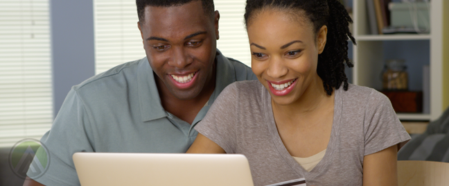 smiling-couple-looking-at-laptop-computer