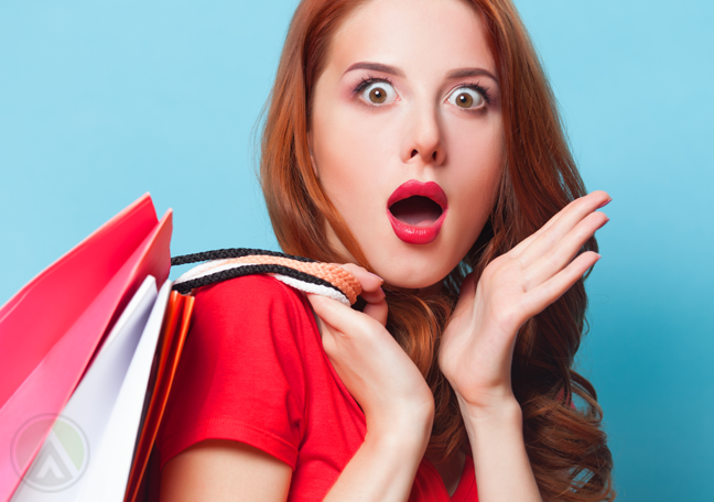 surprised-female-in-red-with-shopping-bags