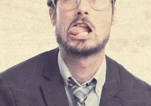 bearded-businessman-in-glasses-tongue-out-making-faces bearded-businessman-in-glasses-tongue-out-making-faces