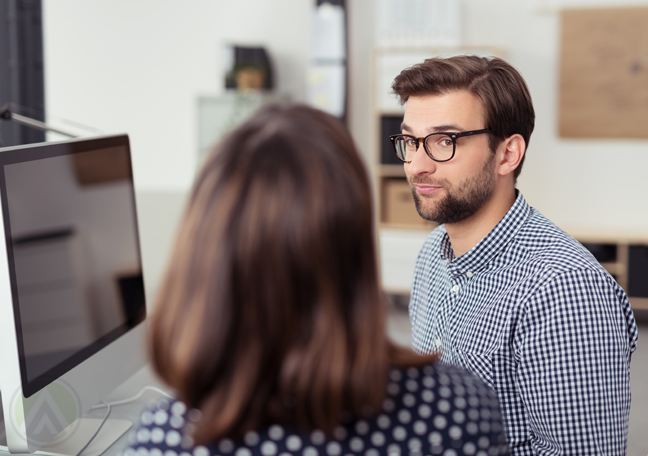 bearded-employee-in-glasses-in-serious-conversation-with-female-boss
