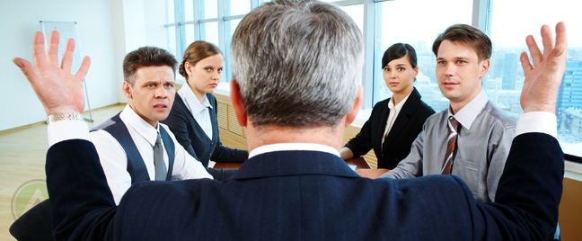 businessman-back-talking-to-business-team