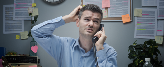 businessman-in-busy-office-scratching-head