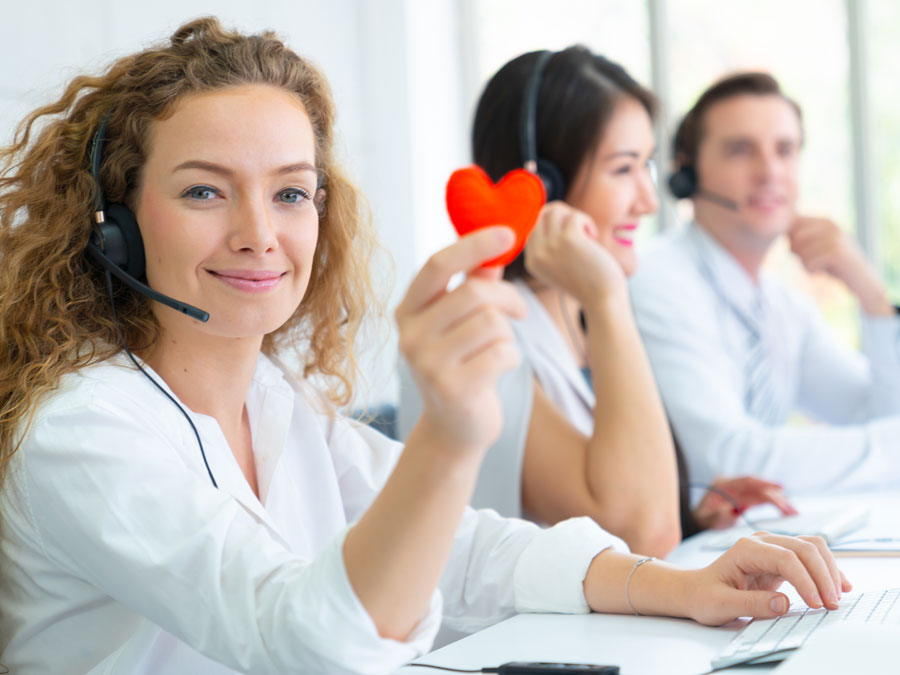 call center team holding red heart