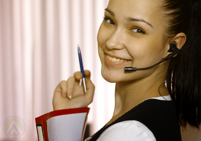 close-up-shot-of-smiling-female-customer-service-agent-holding-pen