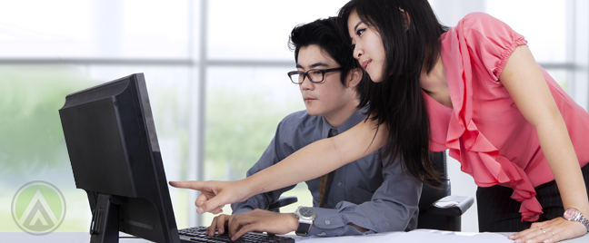 filipino-office-workers-pointing-at-coworkers-computer-monitor