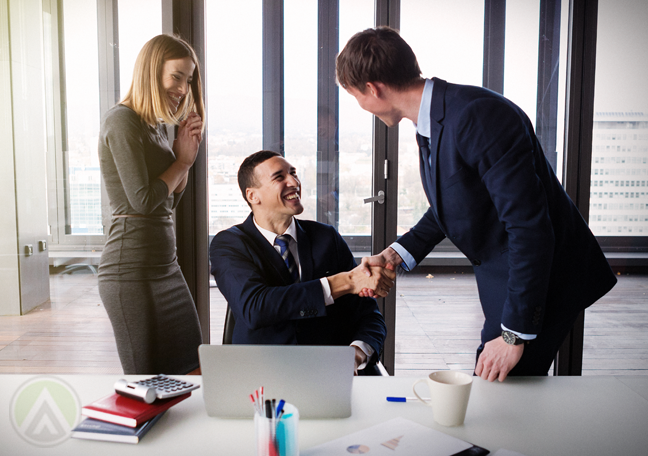 happy-business-team-shaking-hands