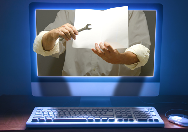 man-holding-paper-instructions-and-wrench-coming-out-of-computer-monitor