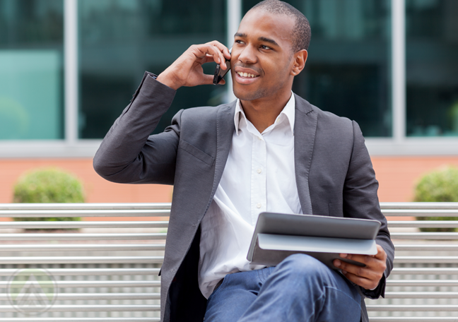 man-in-phone-call-using-tablet-sitting-on-park-bench-outdoors