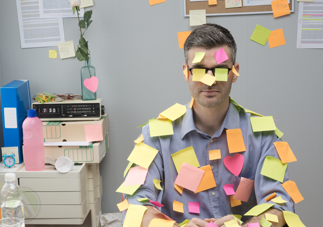 businessman-in-office-covered-in-posti-it-notes