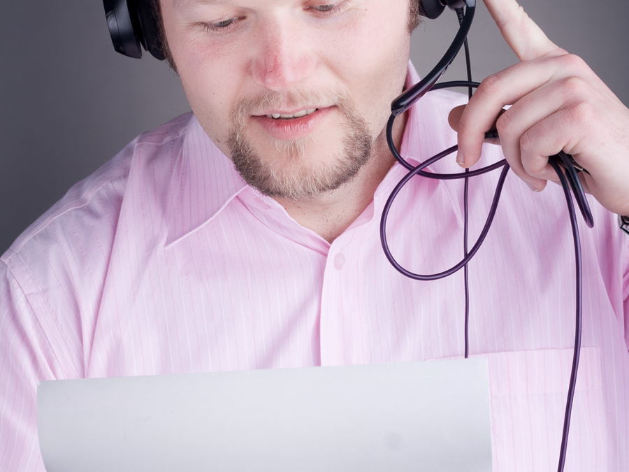 call center agent in pink reading sheet of paper