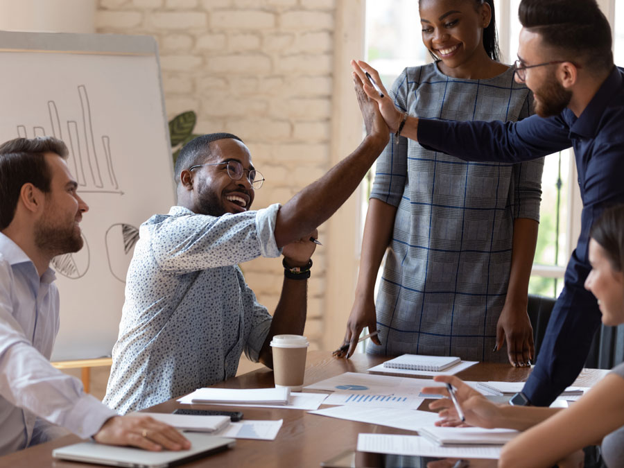 employees giving high five during work training