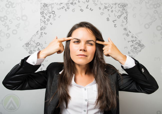 female-business-executive-with-headache-surrounded-by-numbers