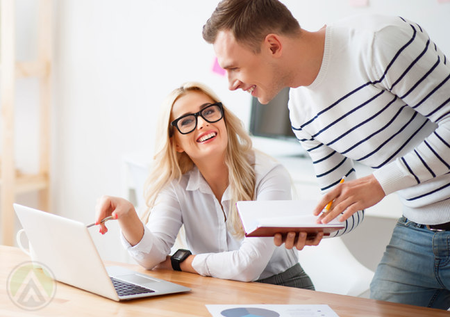 smiling-couple-looking-at-laptop