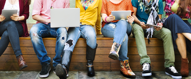 young-people-sitting-holding-laptops