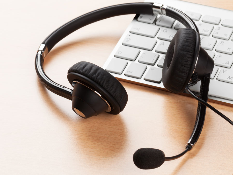 branded customer service strategy depiction call center headset on computer keyboard