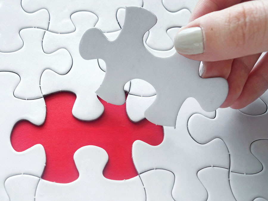 branded customer service strategy depiction hand putting together jigsaw puzzle piece