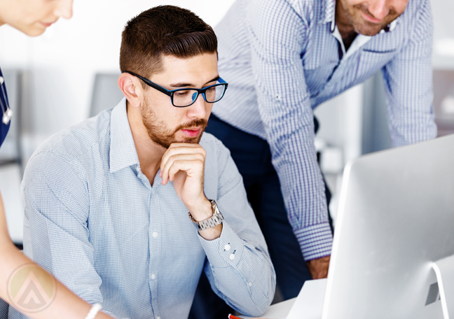 business-team-looking-at-laptop