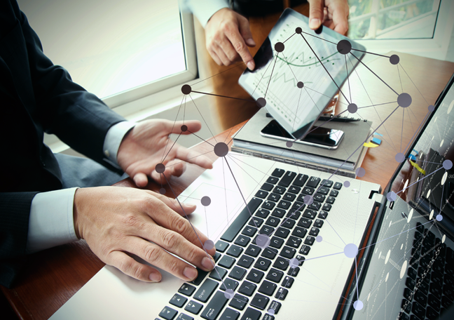 businessman-using-laptop-employee-handing-tablet