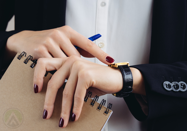 close up female executive looking at wristwatch