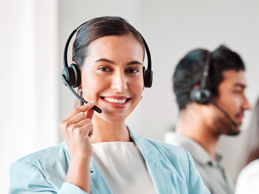 customer relationship management system benefits cx agent smiling in customer support in call center