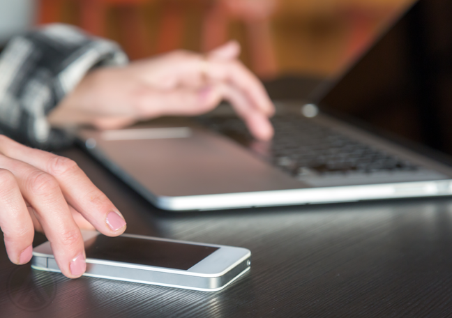 employee-hands-using-laptop-smartphone