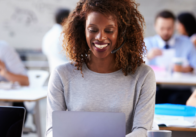 female customer service representative in a call using laptop