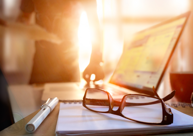 glasses-notepad-by-laptop-man-with-clipboard-in-sunset