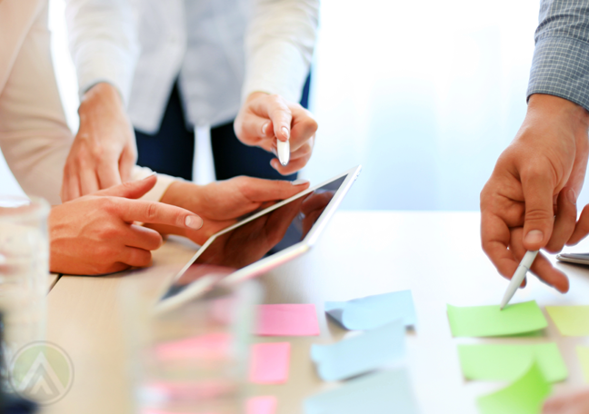 hands-holding-tablet-pen-pointing-to-post-it-notes