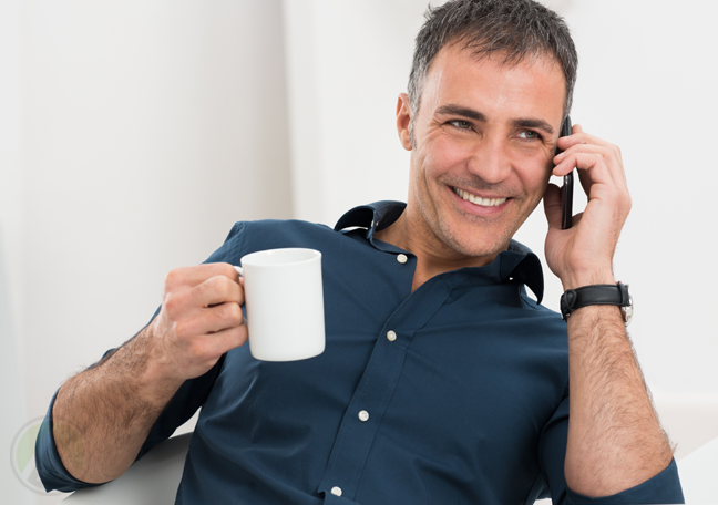 man-with-coffee-enjoying-conversation-over-phone