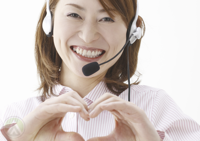 smiling-asian-call-center-agent-forming-heart-with-hands