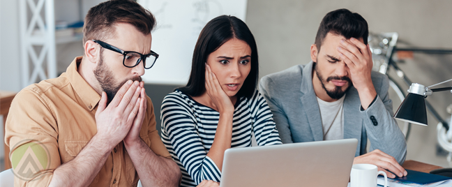 worried-business-team-looking-at-laptop