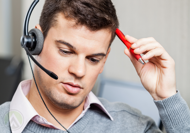 confused call center employee scratching head with pen