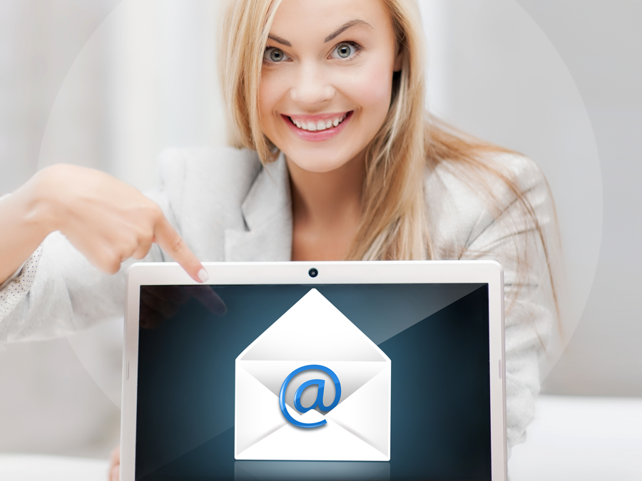 delighted email support agent pointing to email icon on laptop