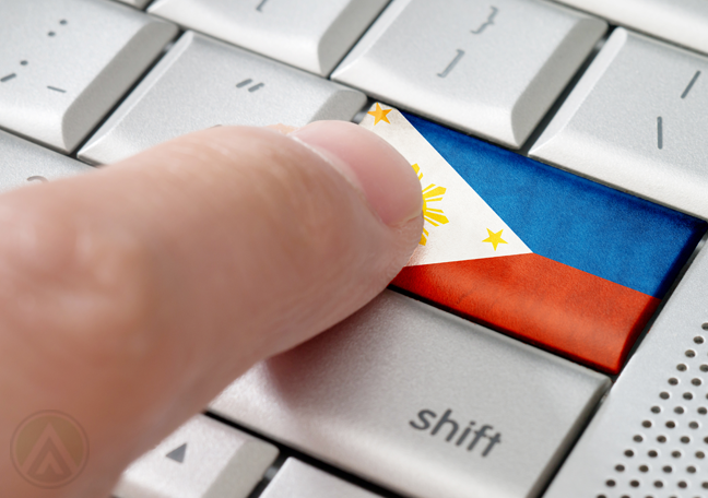 finger pushing keyboard button with Philippine flag